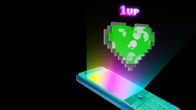 A retro phone’s screen glows onto a ‘1 up’ gaming symbol.